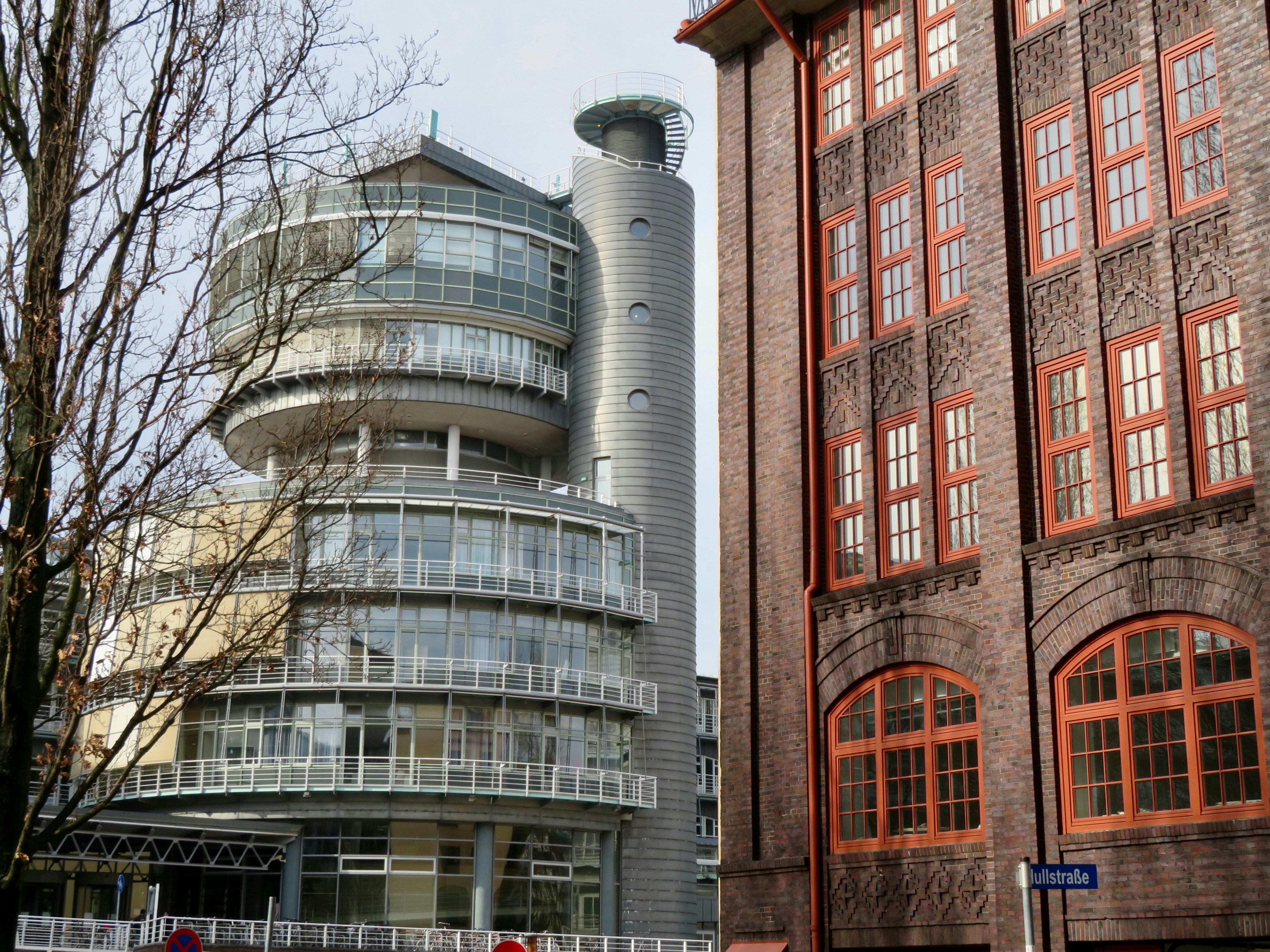 contrasting a modern glass apartment tower with a restored historic building facade - luxury apartments chicago loop