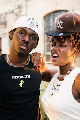 Two stylish young people wearing matching shirts.