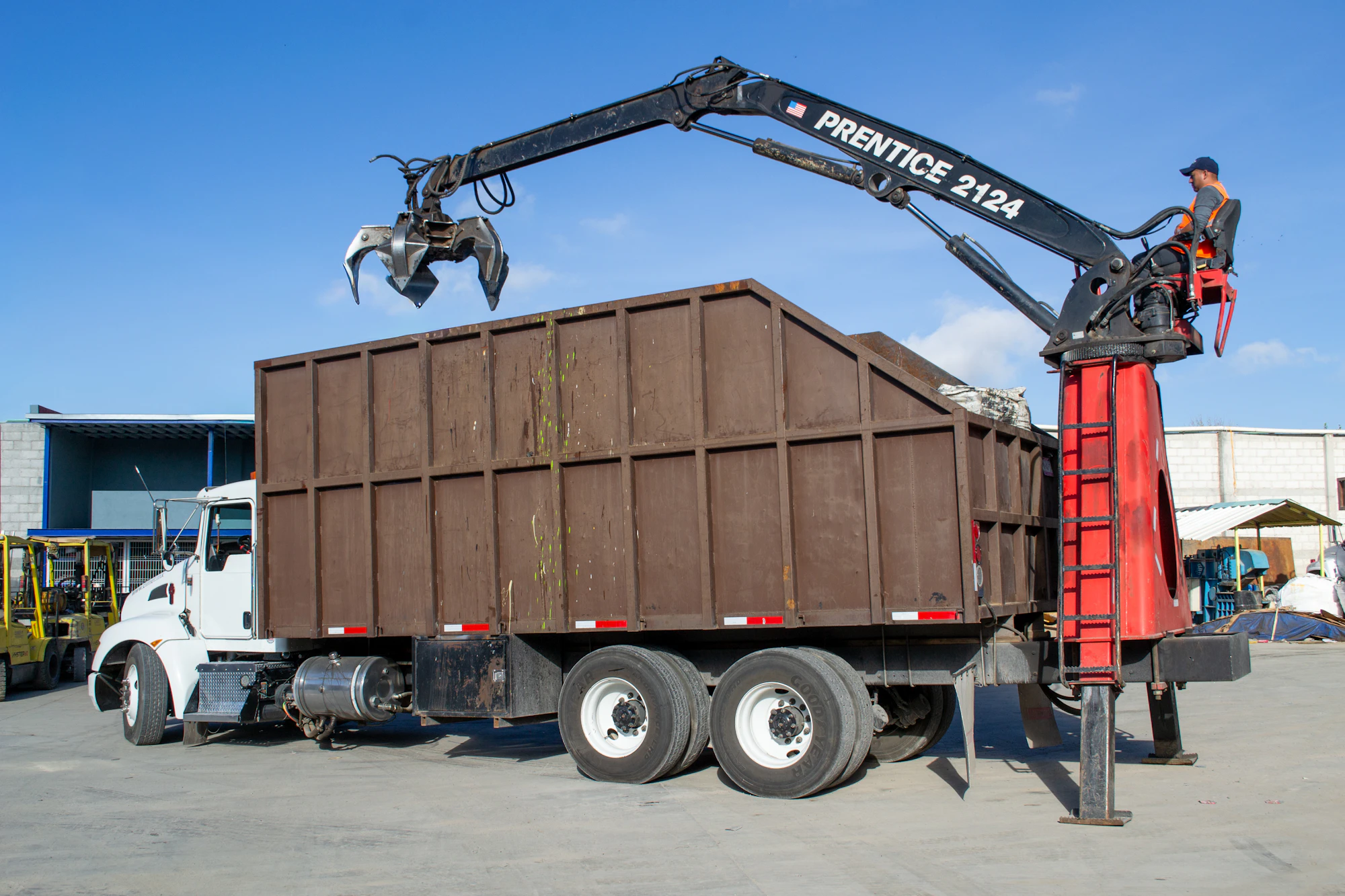 Debris hauling truck with loading equipment