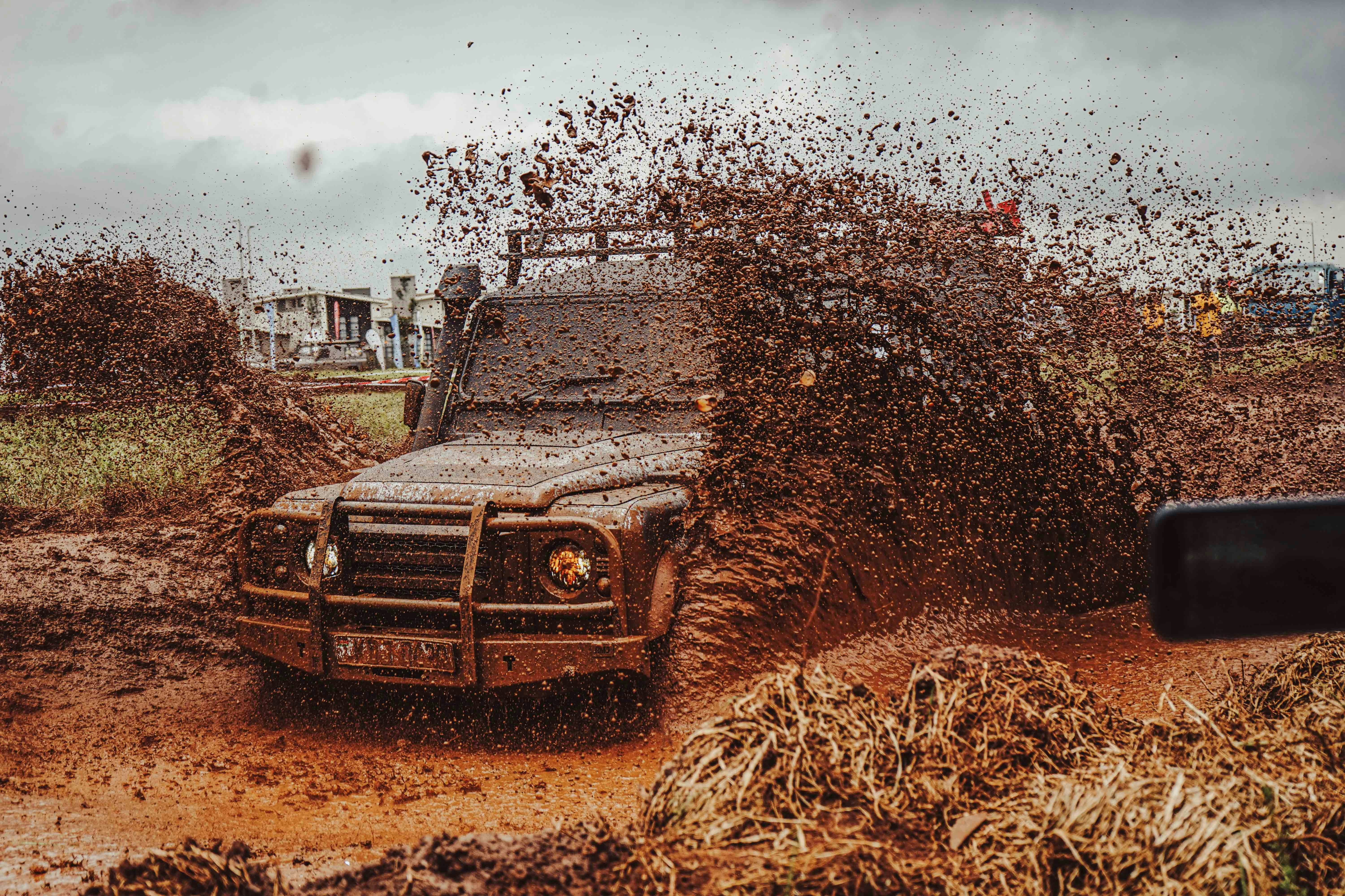 Off-road vehicle splashing through mud