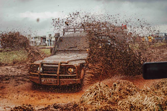 Off-road vehicle splashing through mud