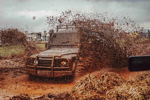 Off-road vehicle splashing through mud