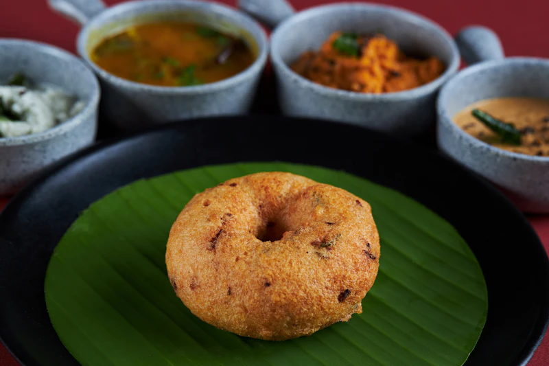 Vadas served with chutneys and sambar