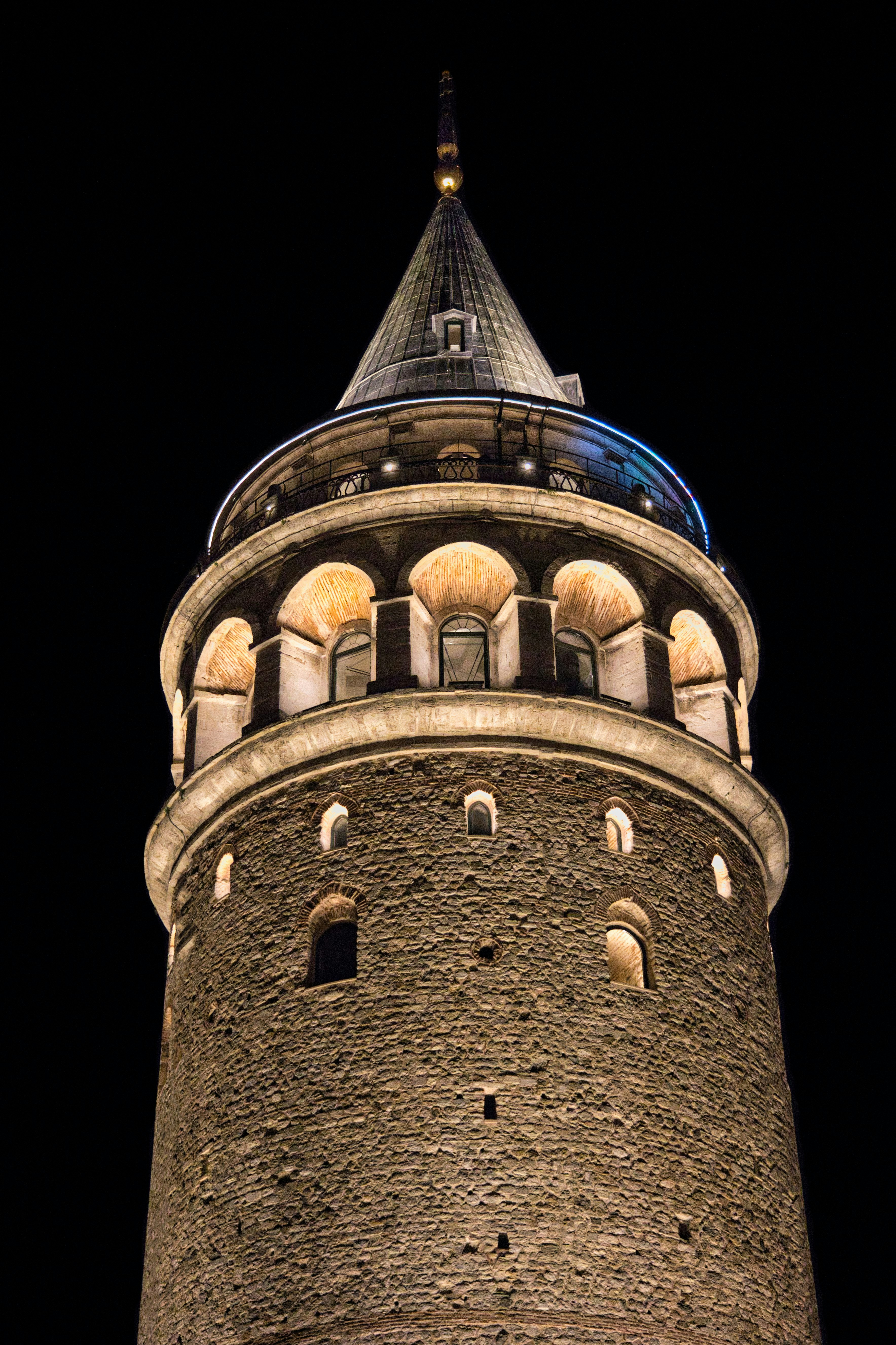 Galata tower illuminated at night against a dark sky