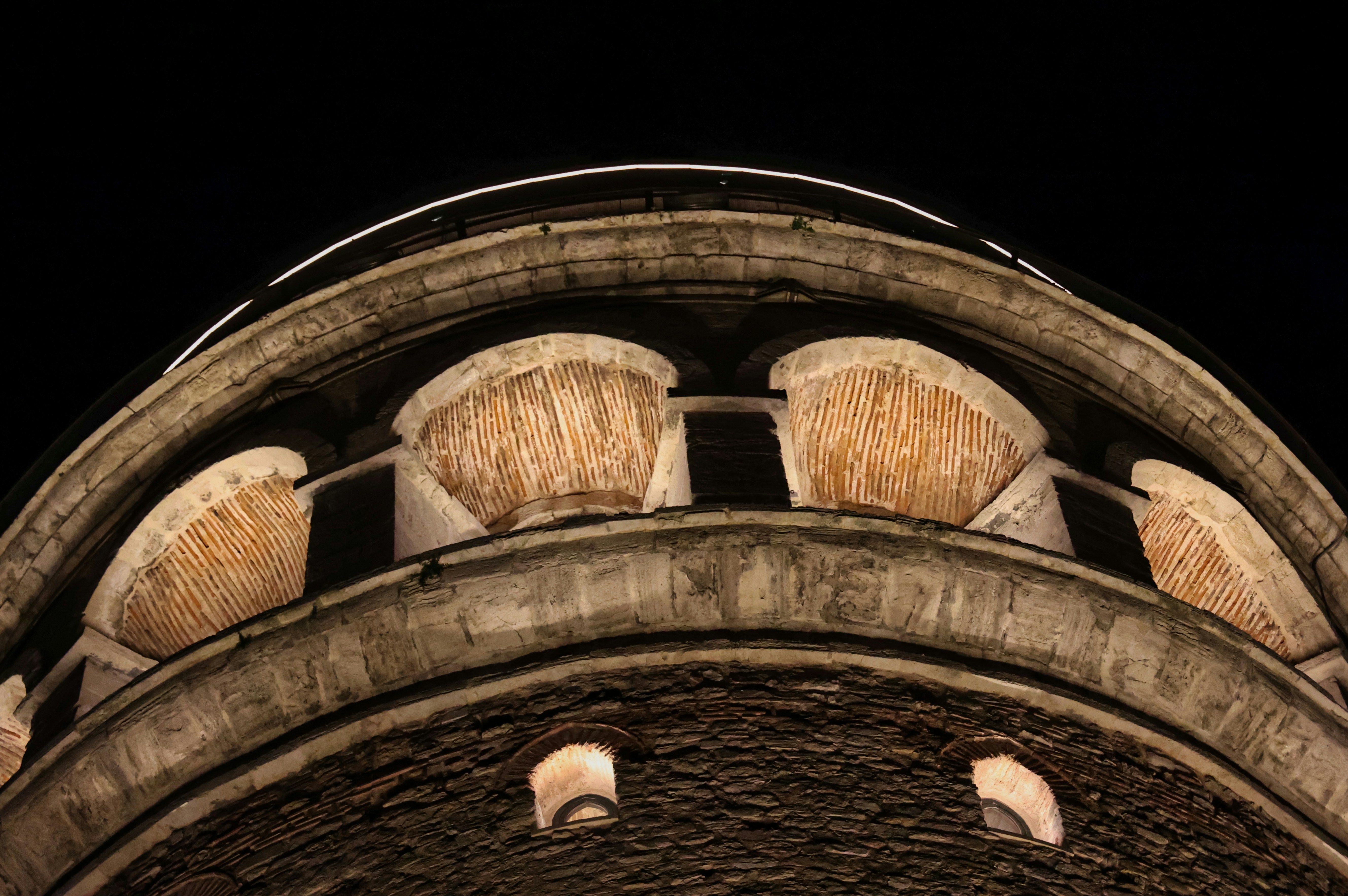 Close-up of a historic stone tower at night.