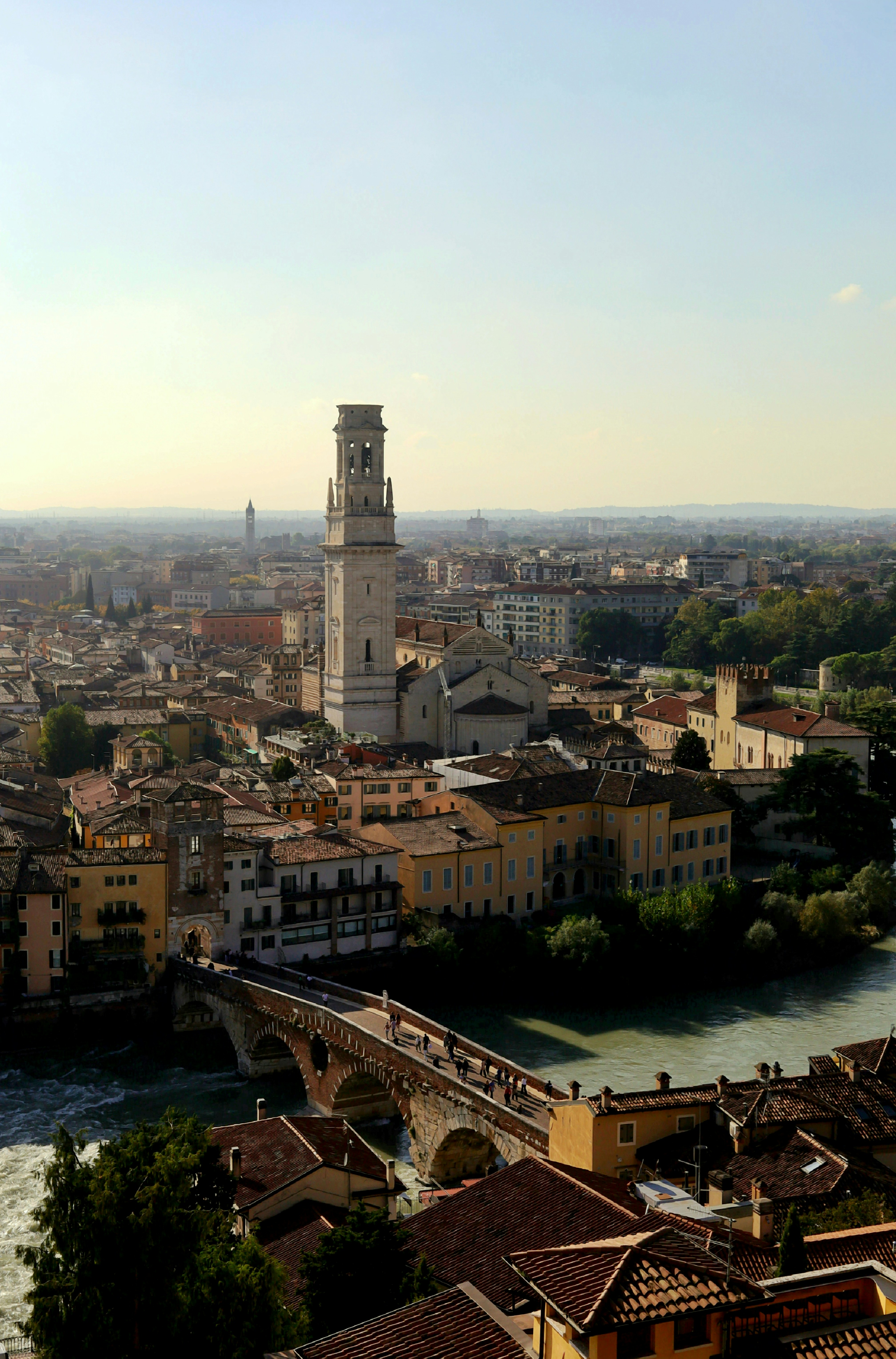 Historic italian city skyline with bridge and river.