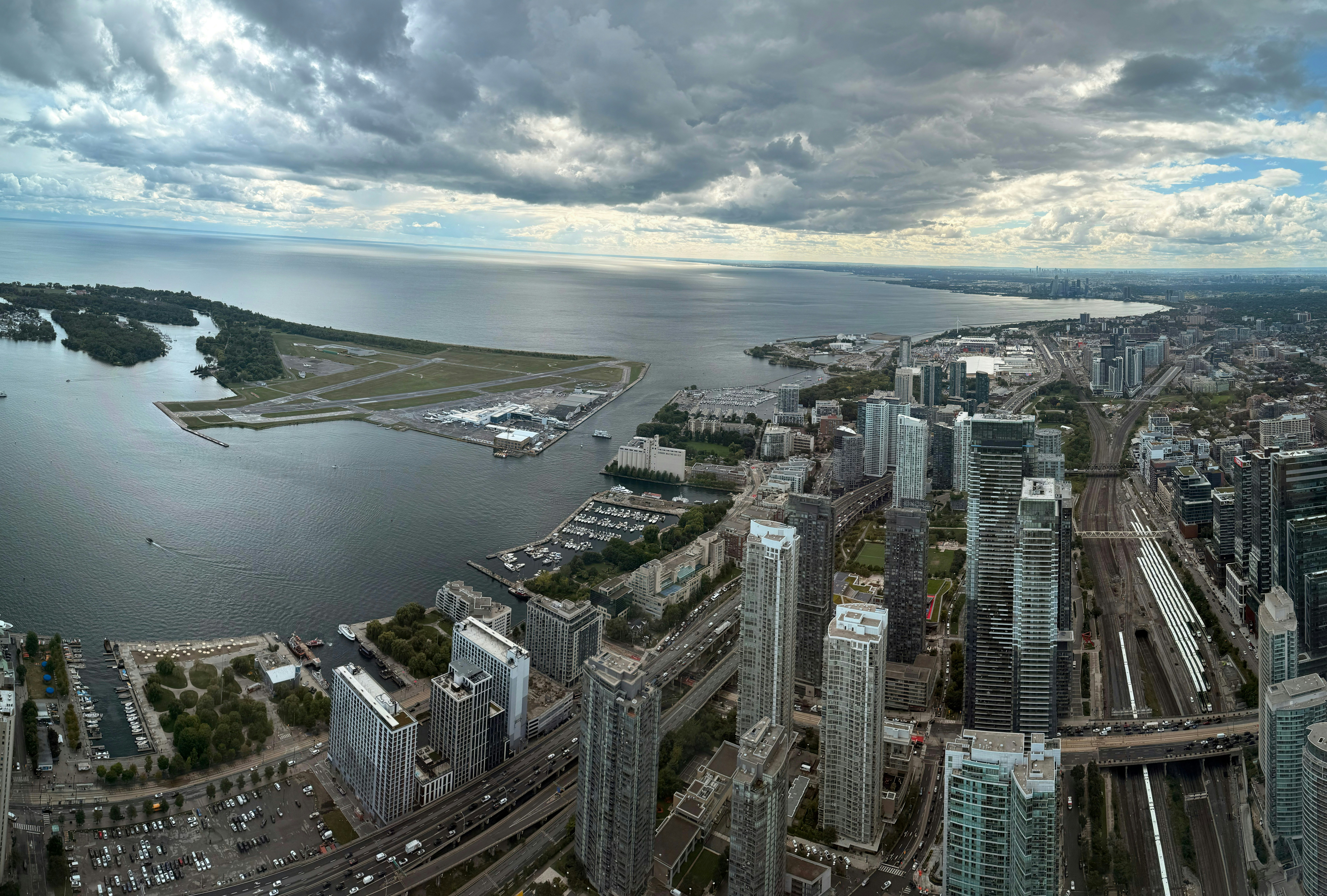 City skyline with lake and airport under cloudy sky