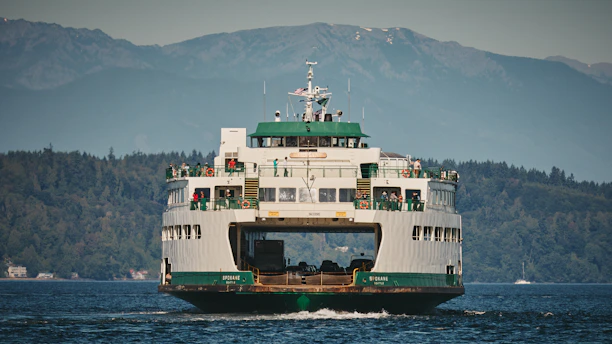 A large ferry boat travels across the water.