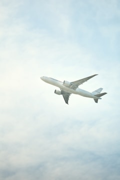 Airplane ascending into a cloudy sky