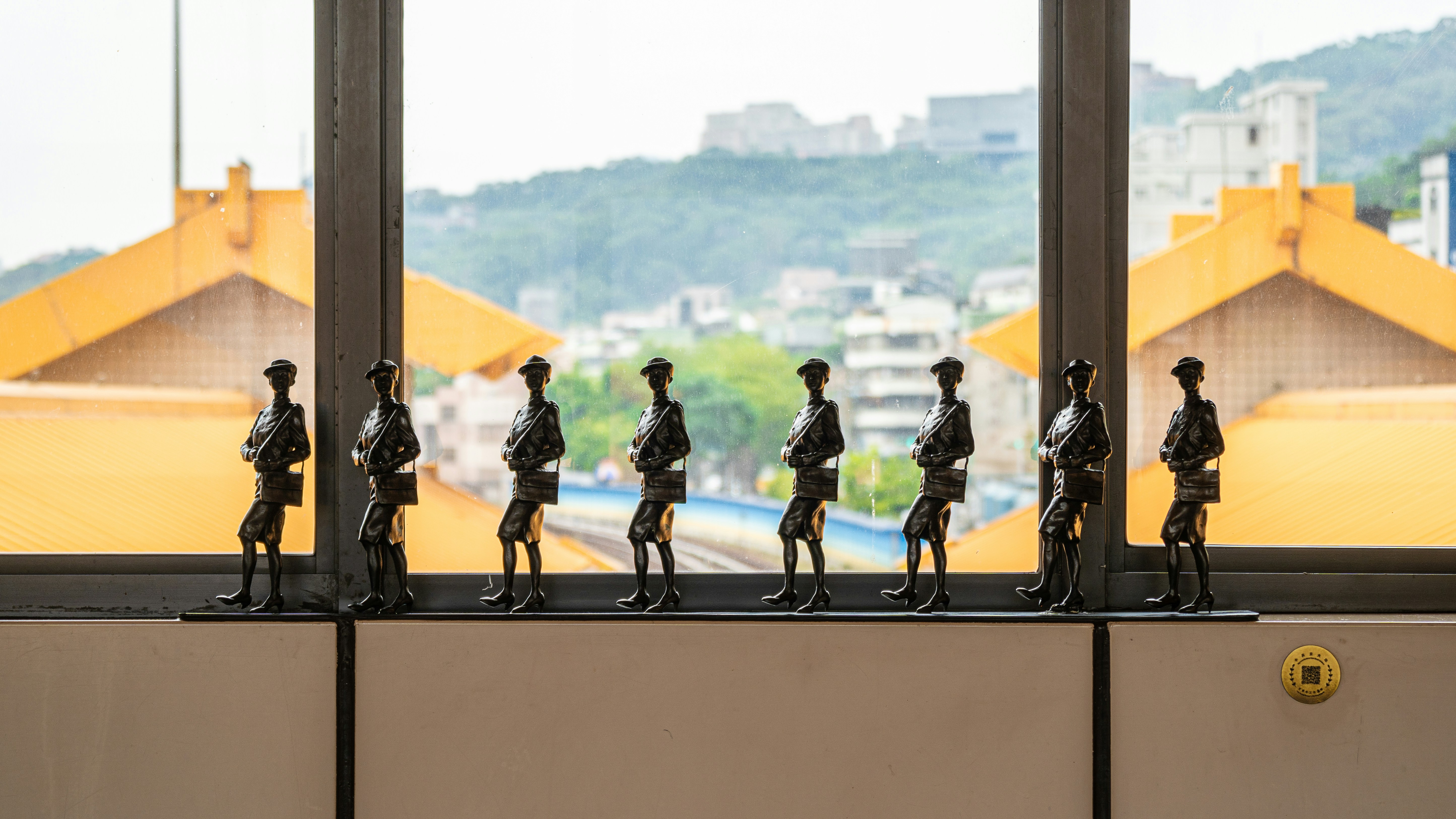 Row of soldier figurines standing by a window