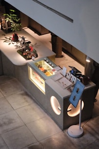 Modern dessert counter with display case and seating area.