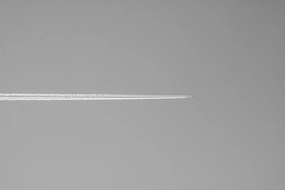 Airplane contrail across a clear sky