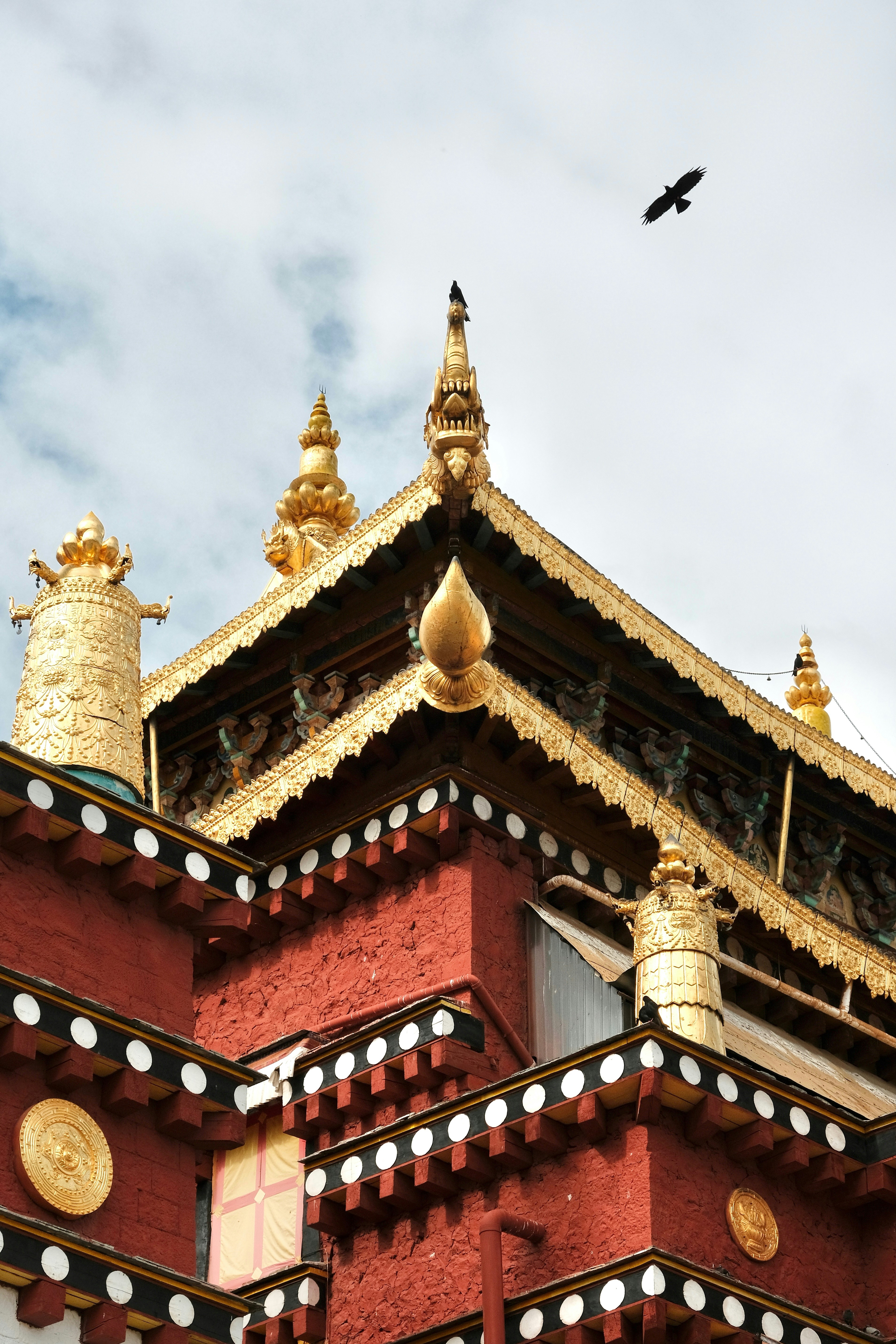 Ornate golden roof of a red tibetan monastery