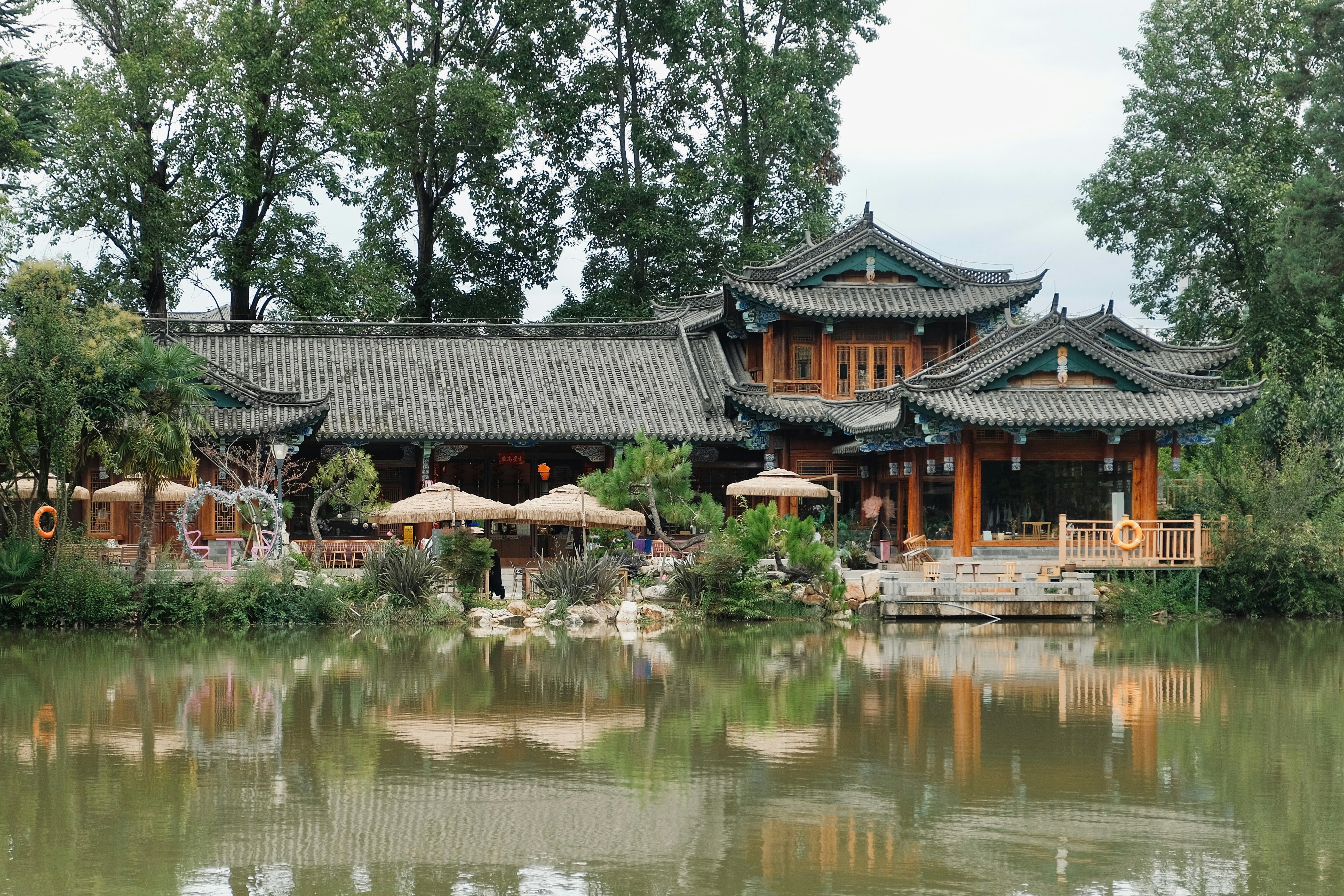 Traditional east asian building by a reflective lake