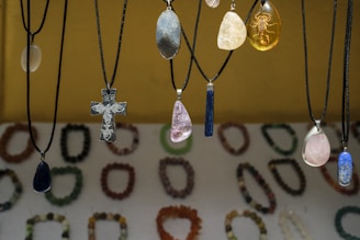 Assortment of necklaces with colorful pendants displayed pendants and unique pendants.