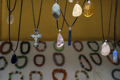 Assortment of necklaces with colorful pendants displayed pendants and unique pendants.