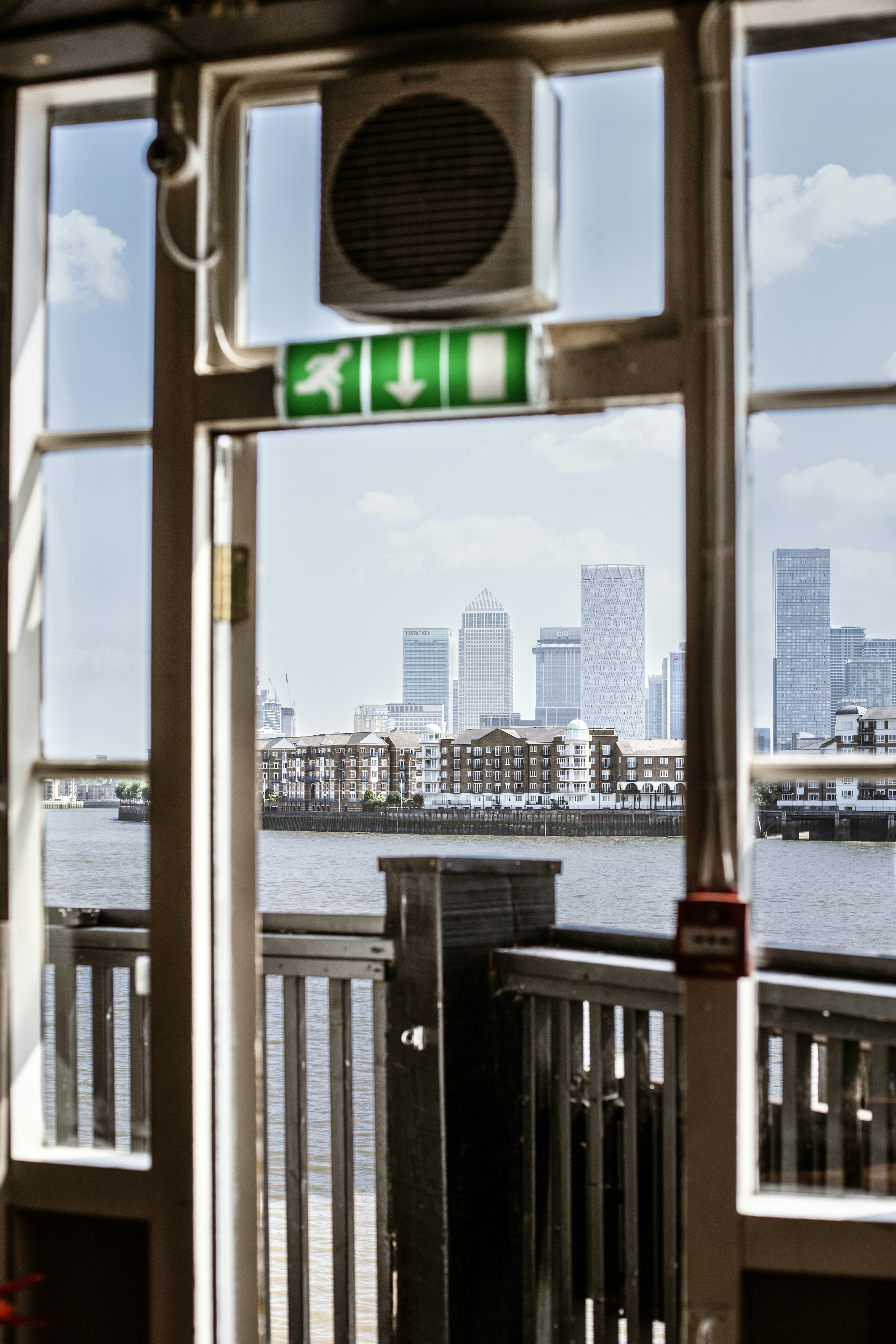 City skyline seen through an open door over water