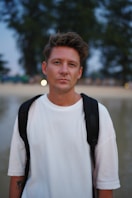 Man with backpack at the beach at dusk