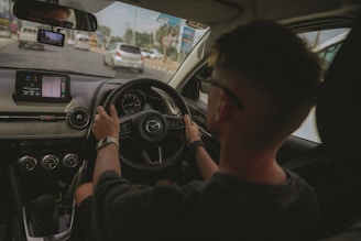 Man driving a car on a sunny day