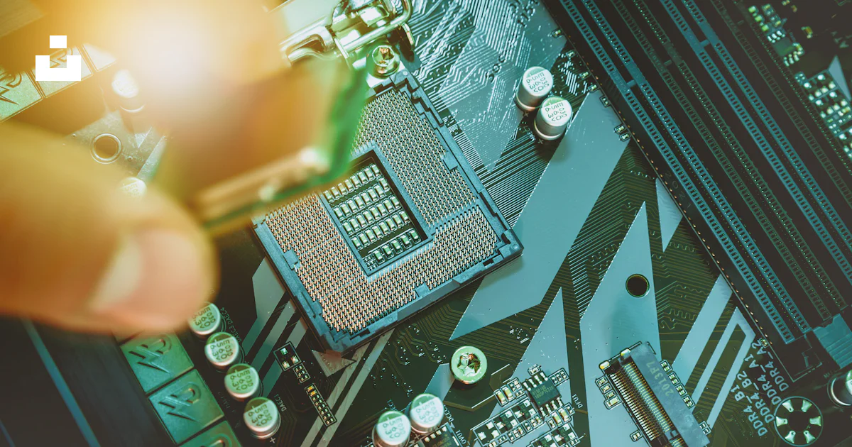 Hand installing a computer processor onto a motherboard. photo – Free ...