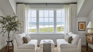 Bright living room with ocean view through large windows