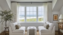 Bright living room with ocean view through large windows