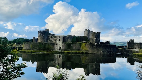 Historic castle surrounded by water under cloudy sky