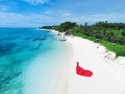 Woman in red dress on a tropical beach