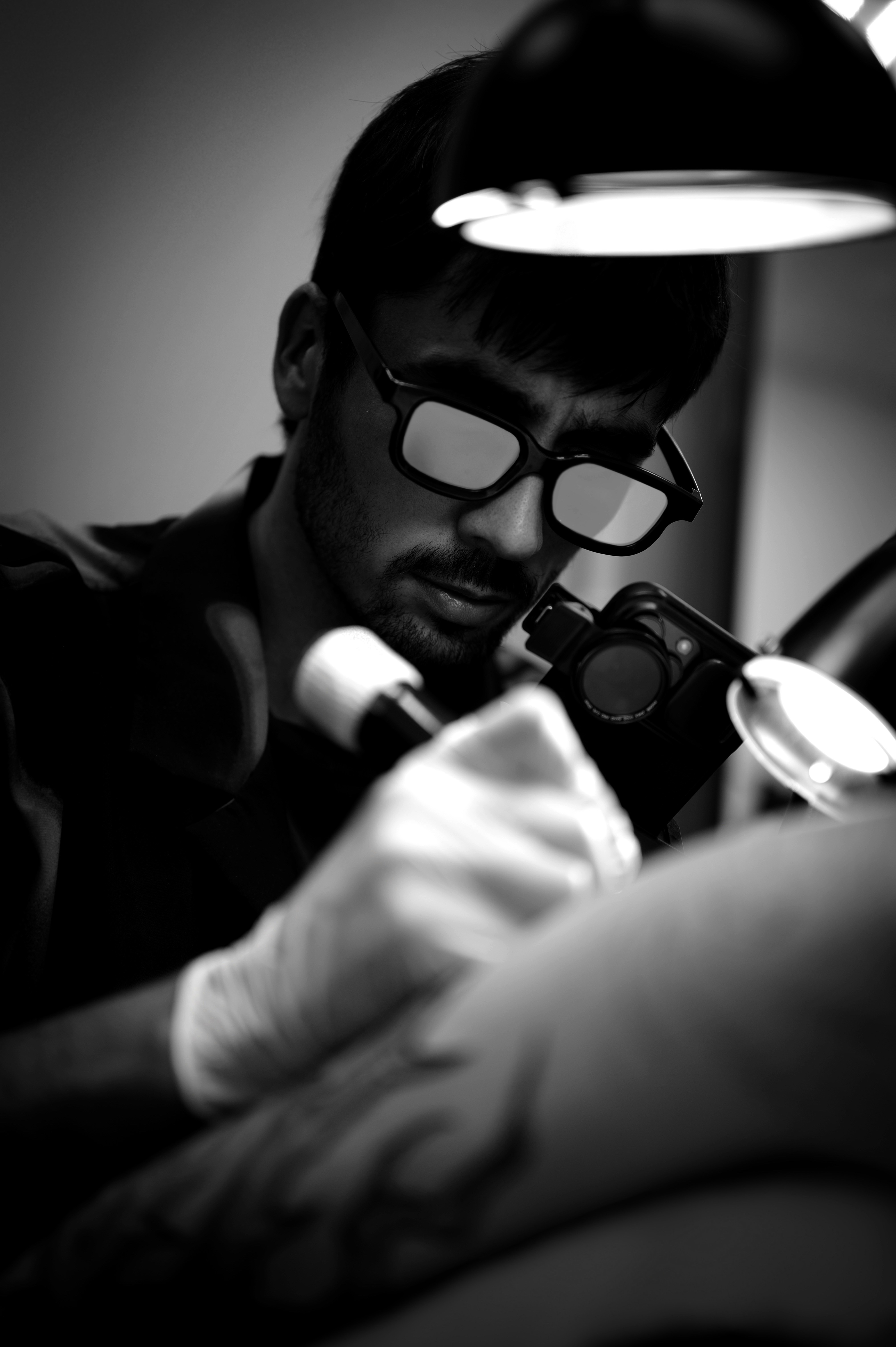 Current placeholder for A doctor applying a treatment to skin.