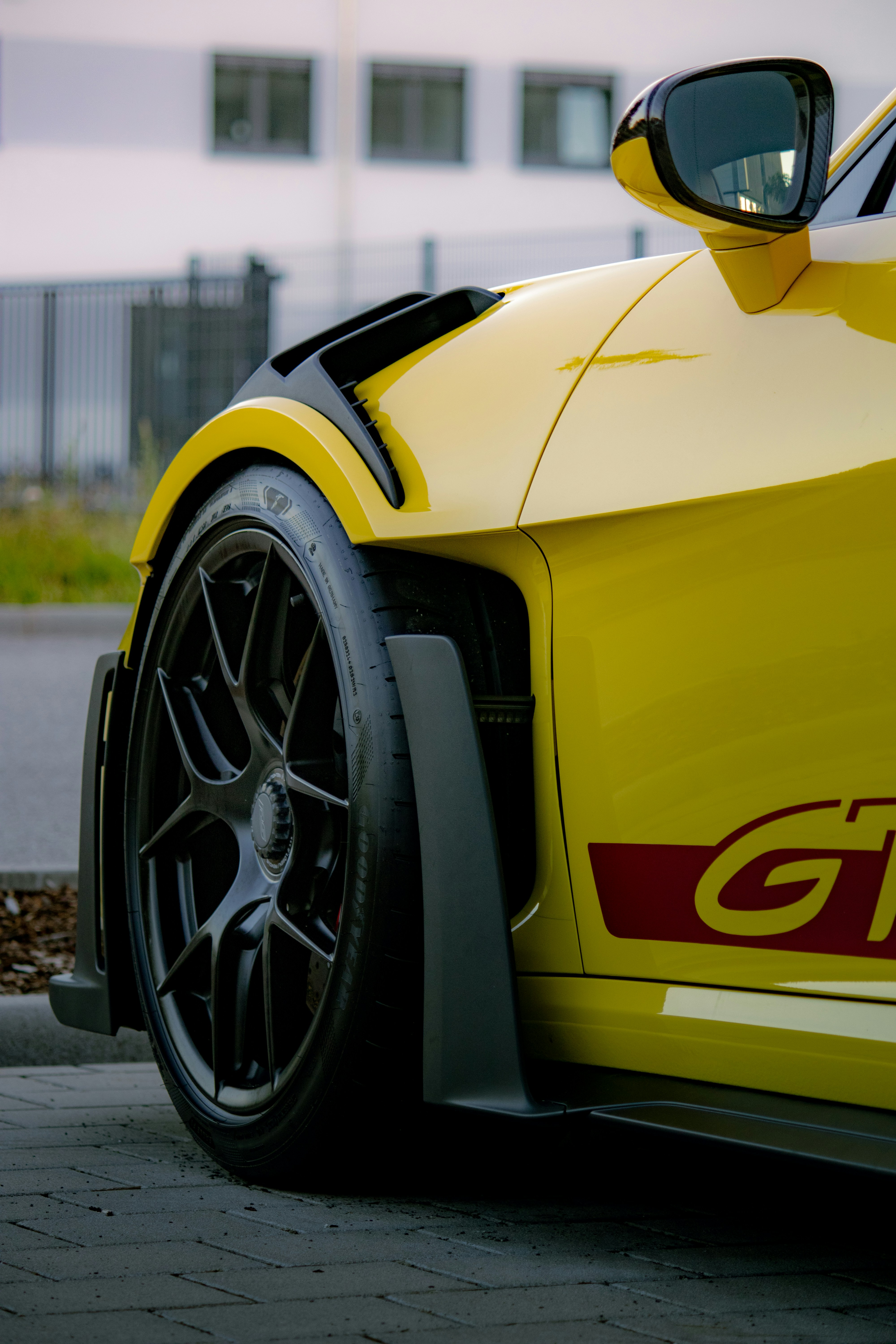 Yellow sports car with black racing wheels