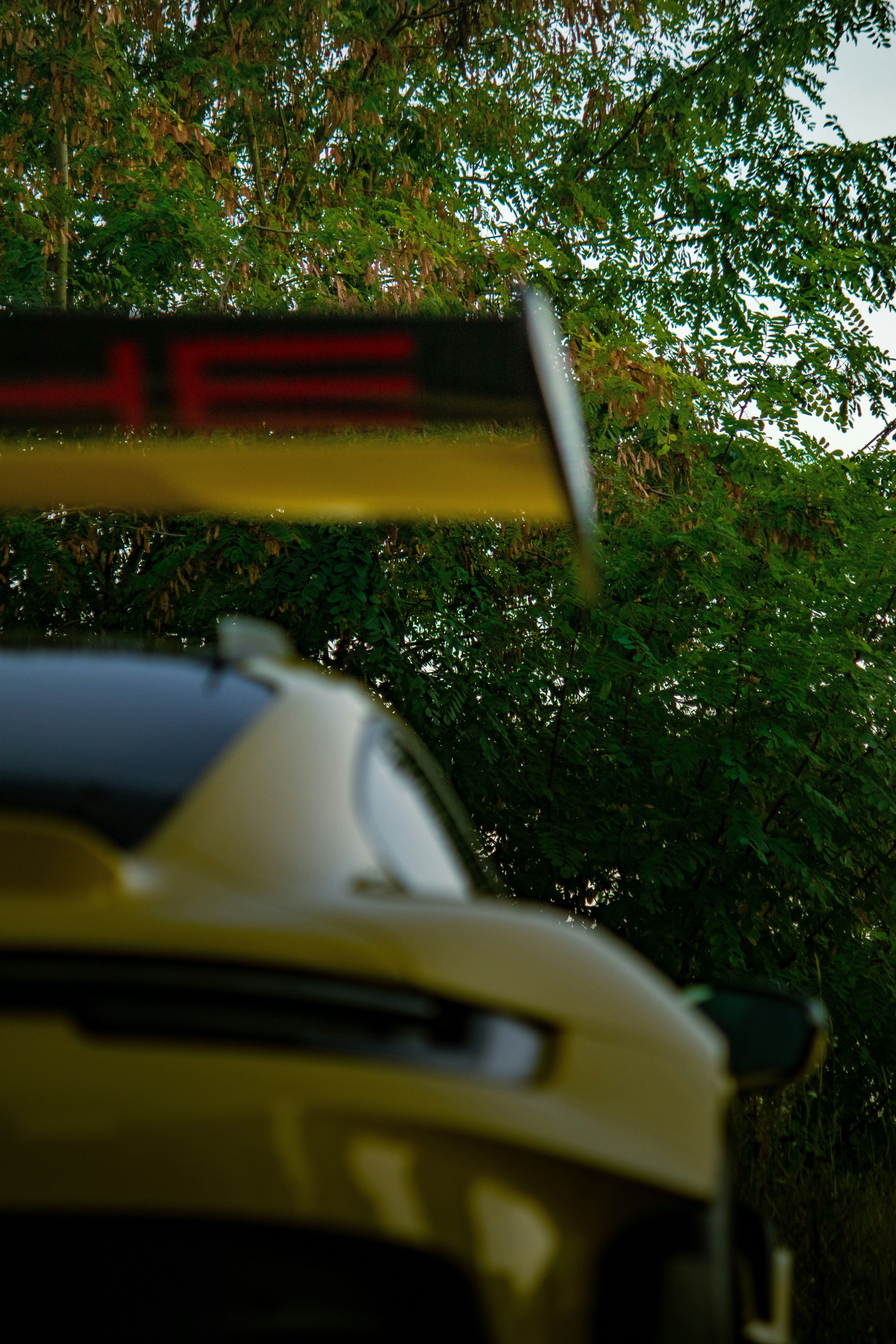 Yellow porsche sports car with rear spoiler
