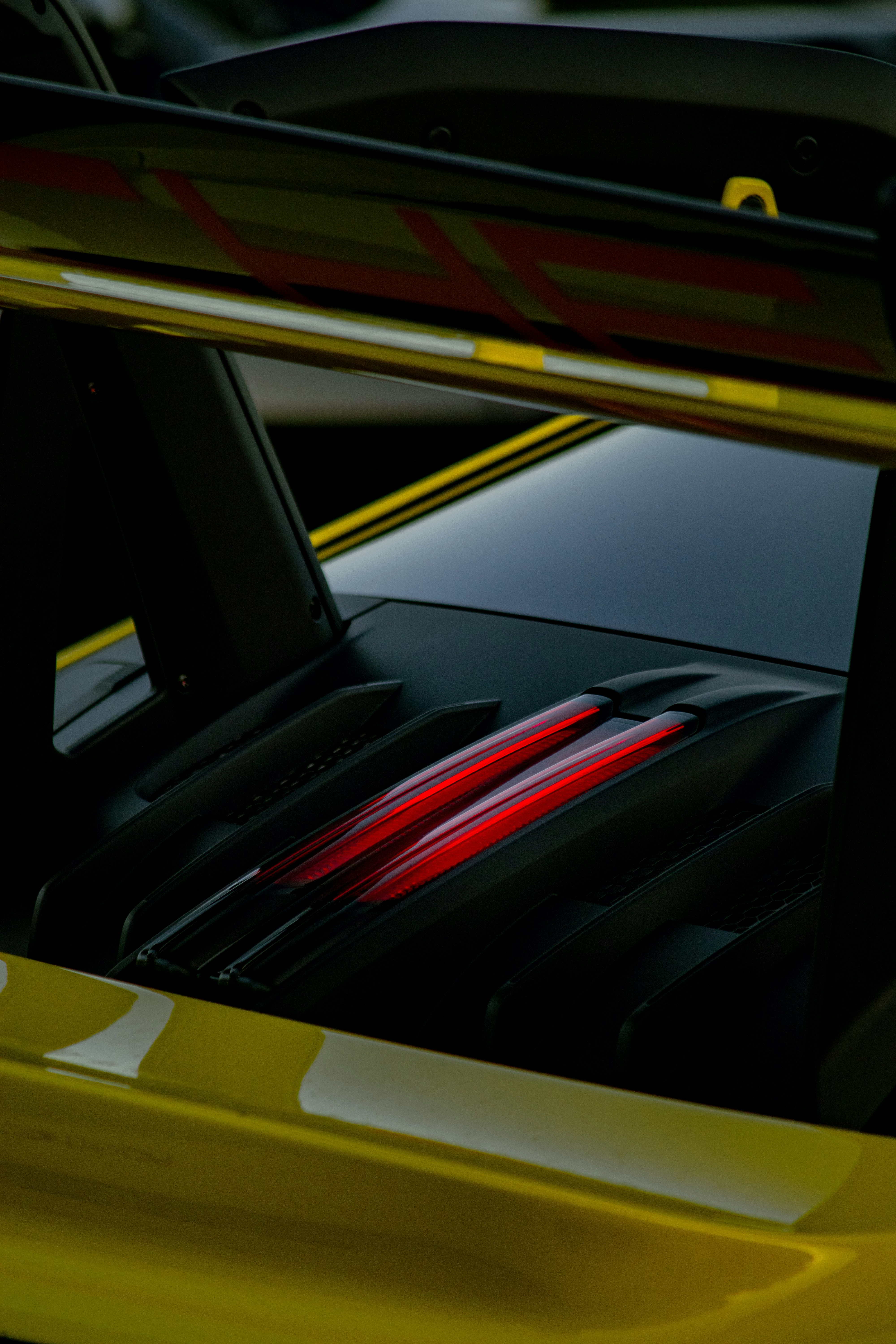 Yellow sports car with glowing red taillights