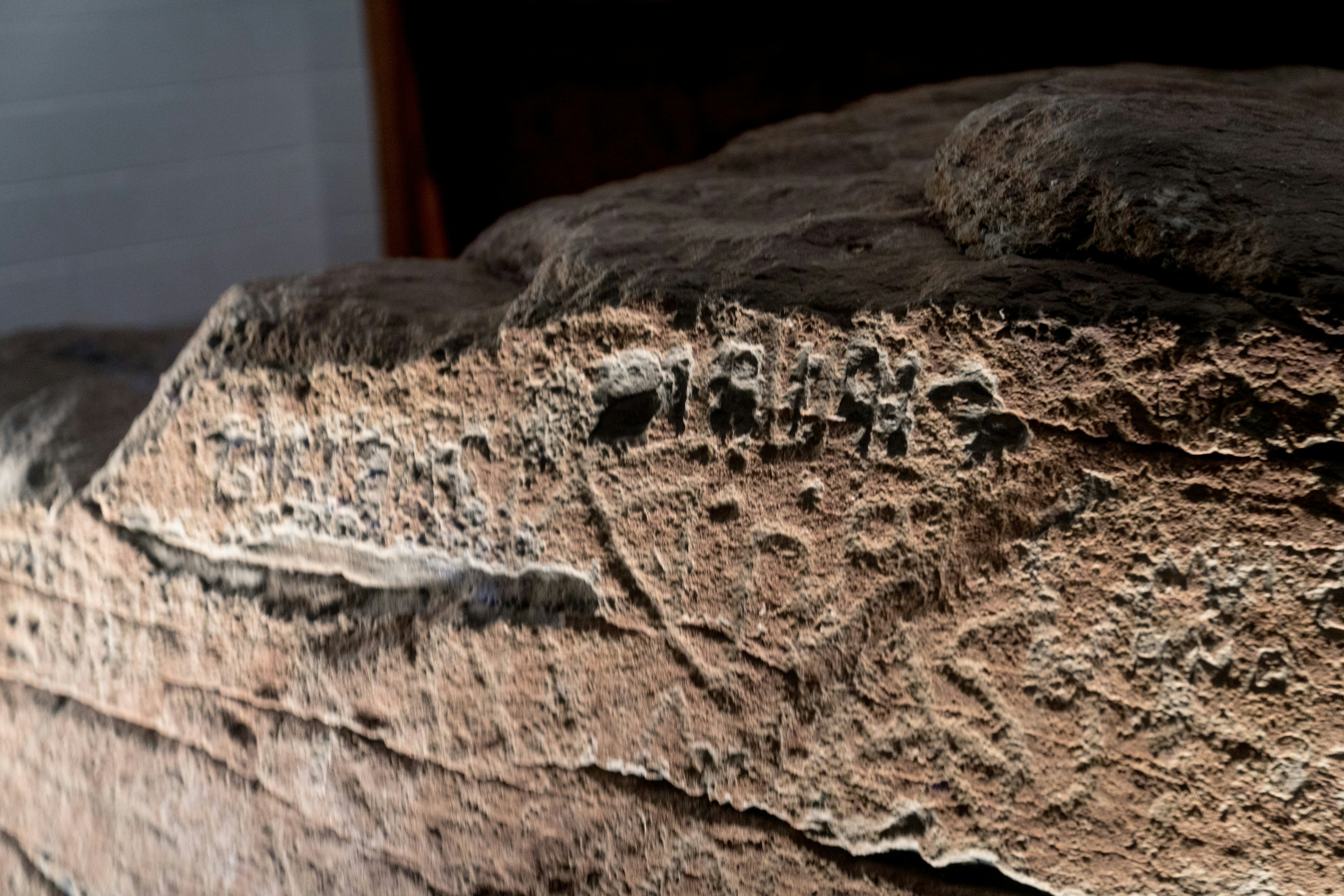 Close up of ancient rock carvings with intricate details.