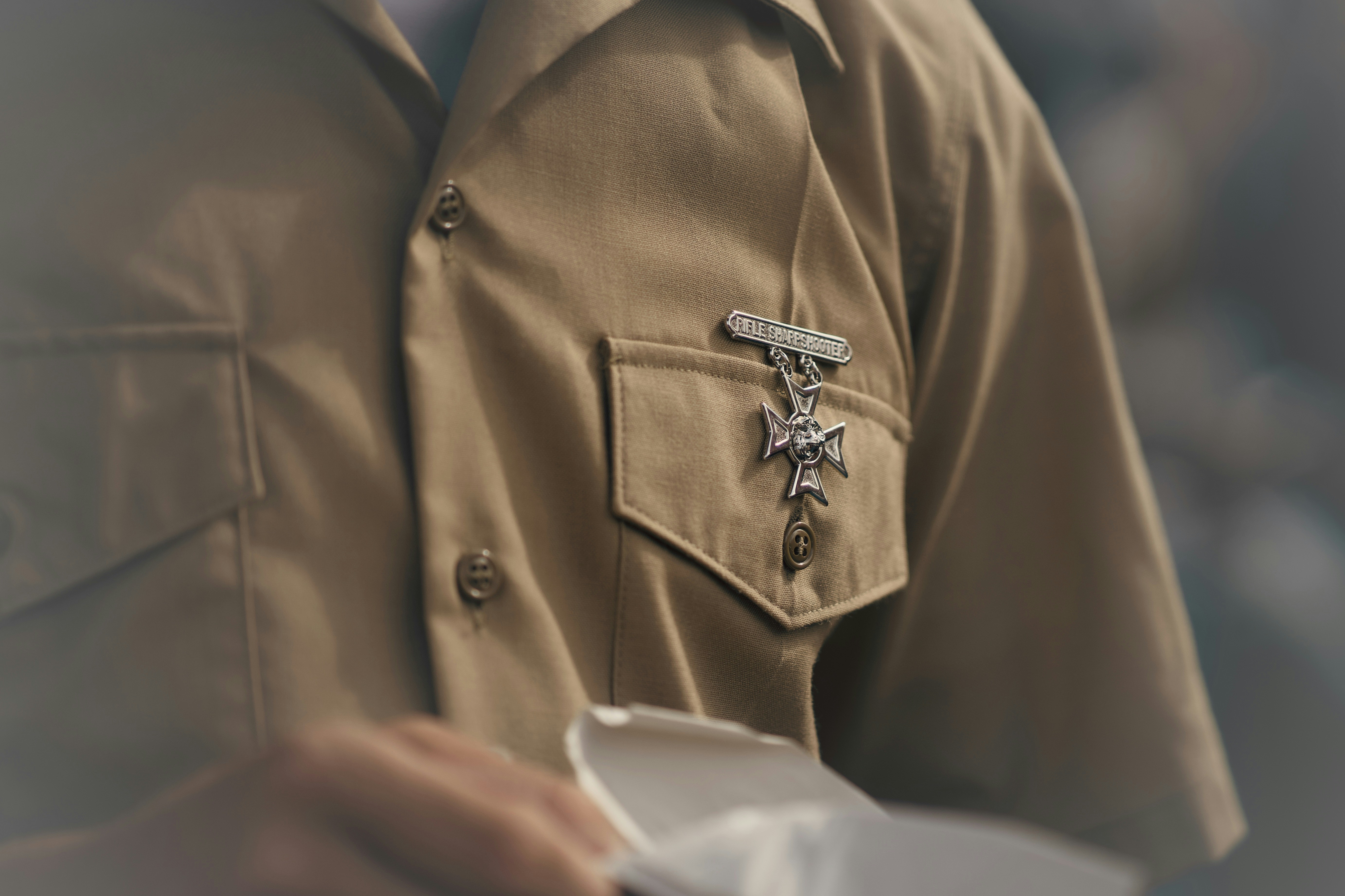 A technician wearing a uniform with a certification badge - certified garage door repair technician in dripping springs tx