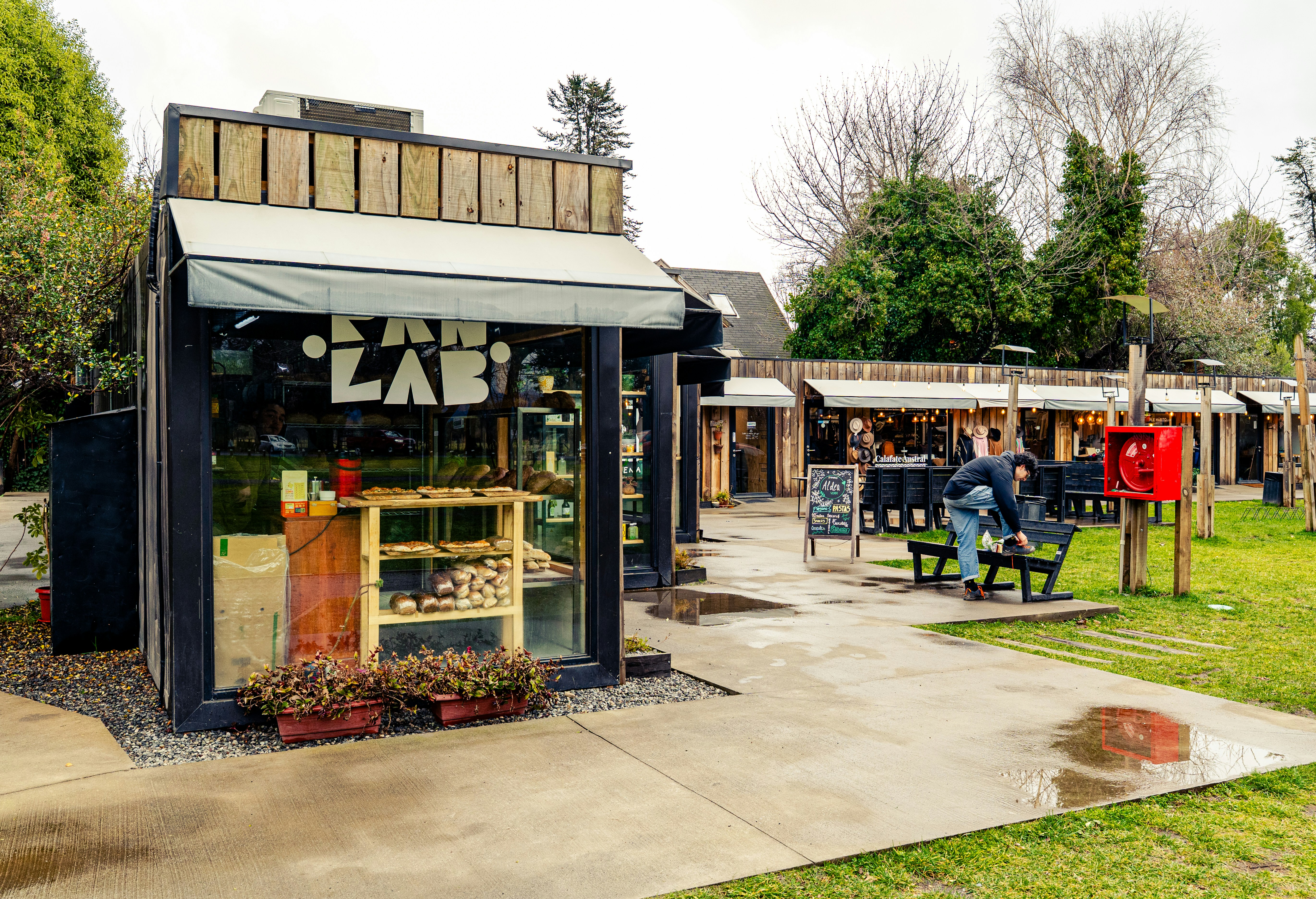 Small market stalls with people in a park.