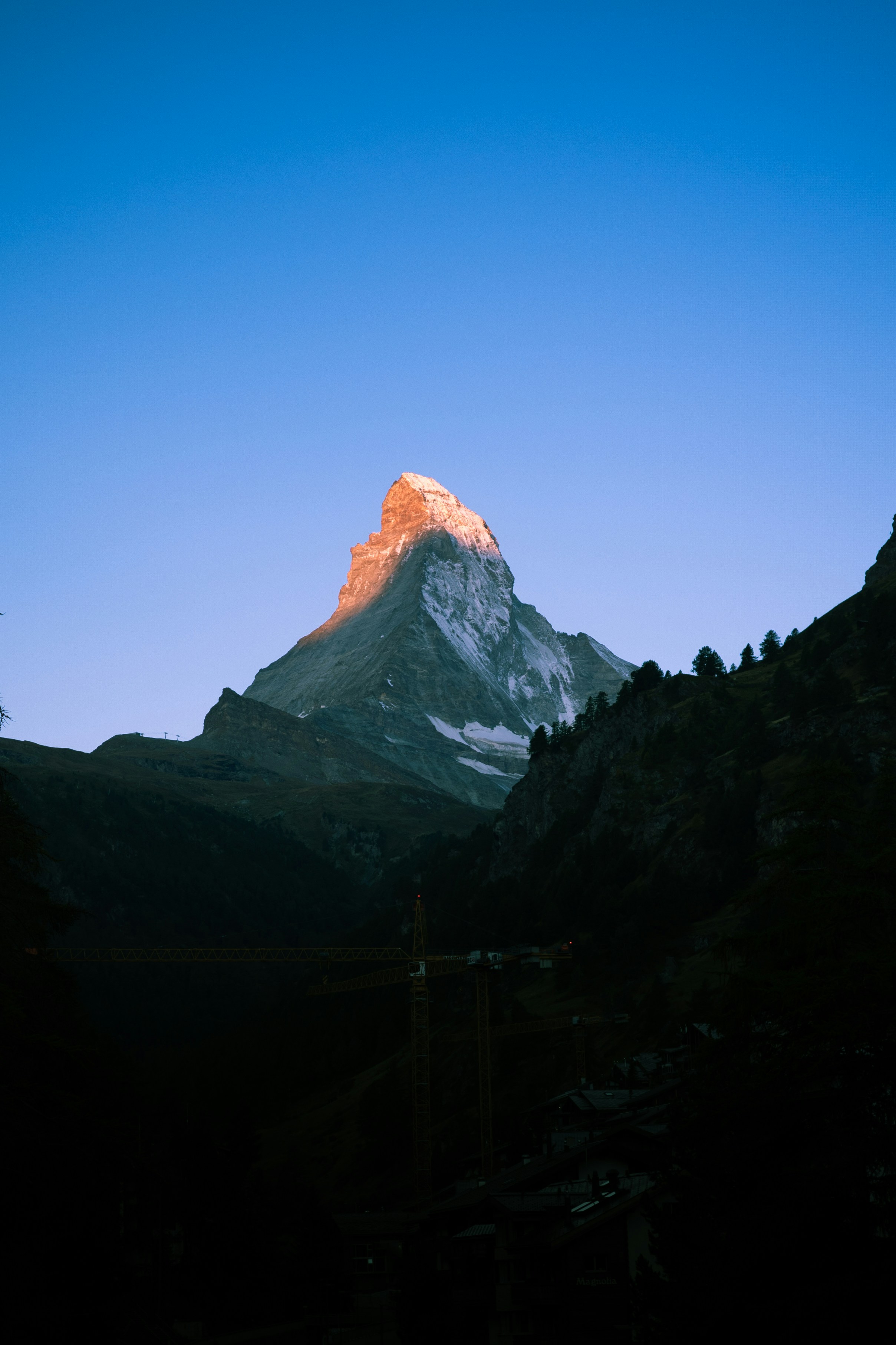 Majestic mountain peak illuminated by golden sunrise light