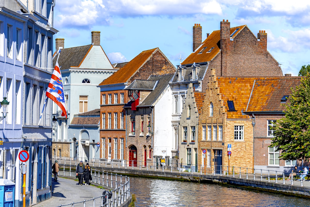 Historic European canal lined with colorful buildings in Bruges