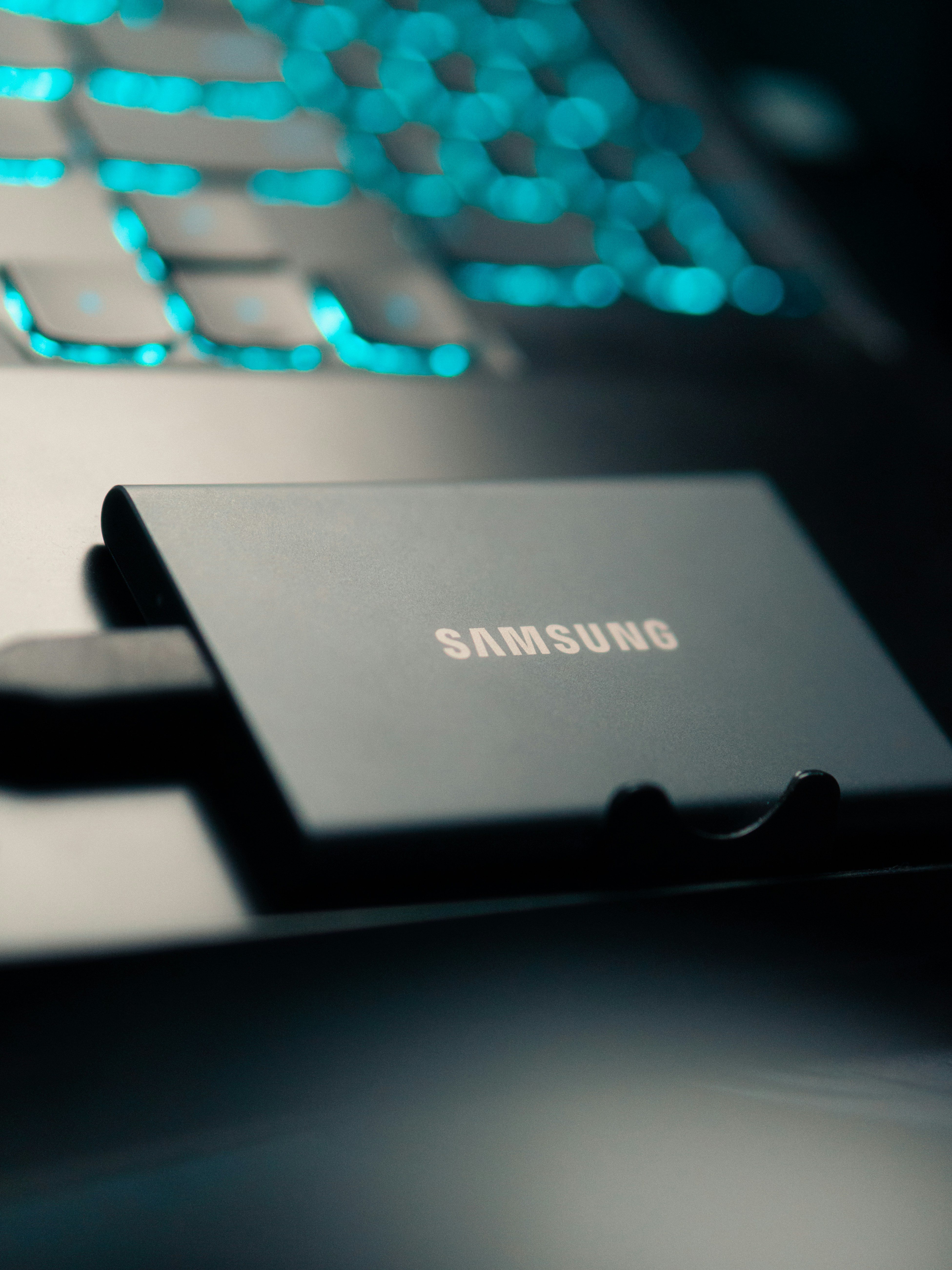 Samsung ssd drive next to a glowing keyboard