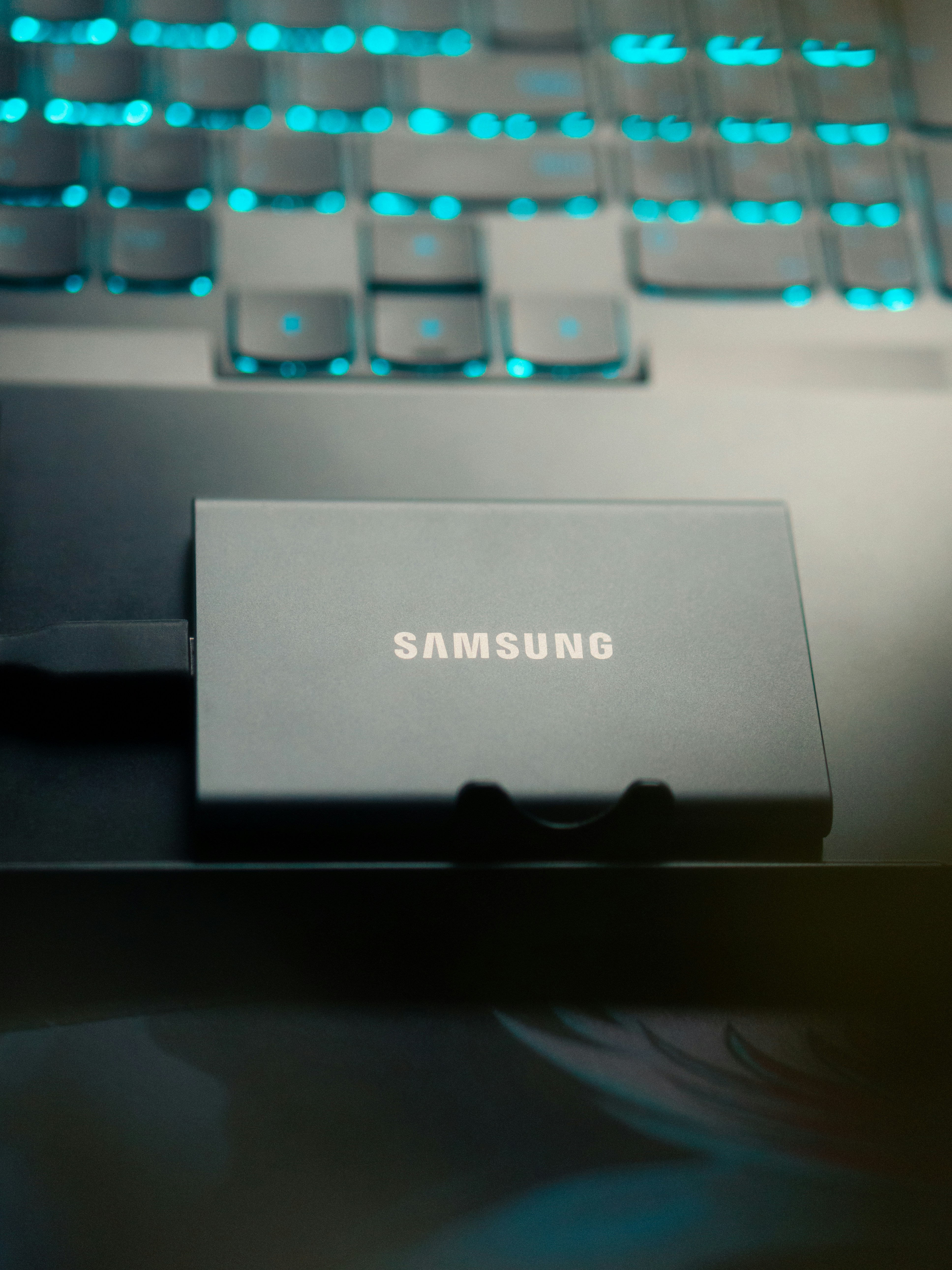 Samsung external ssd connected to a glowing keyboard