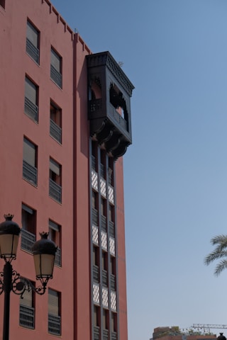 Red building with ornate dark wooden elevator shaft