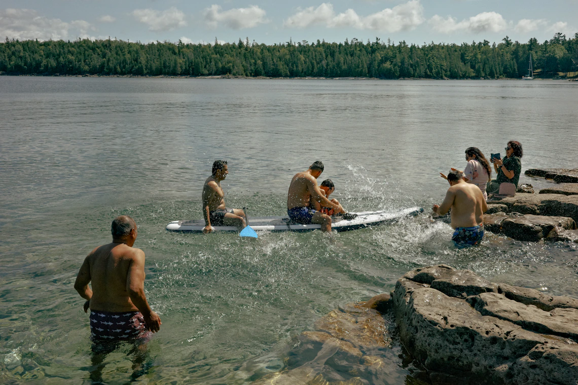 People paddleboarding on calm blue water
