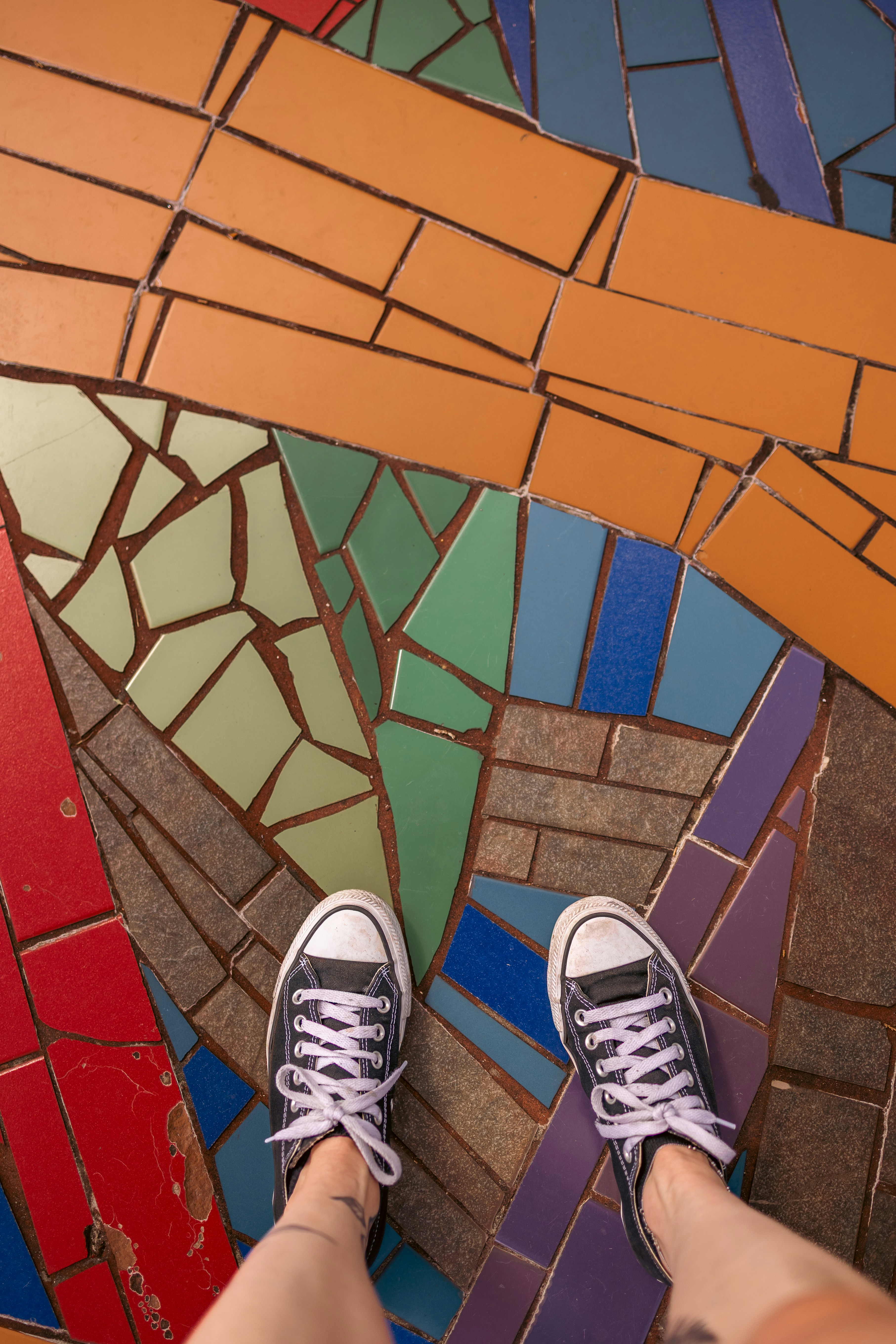 Pés que estão na terra telhada mosaico colorida