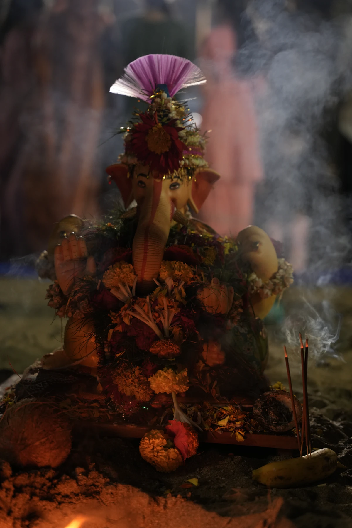 A Ganesha idol with incense at night, closer to a farewell than to a stunt