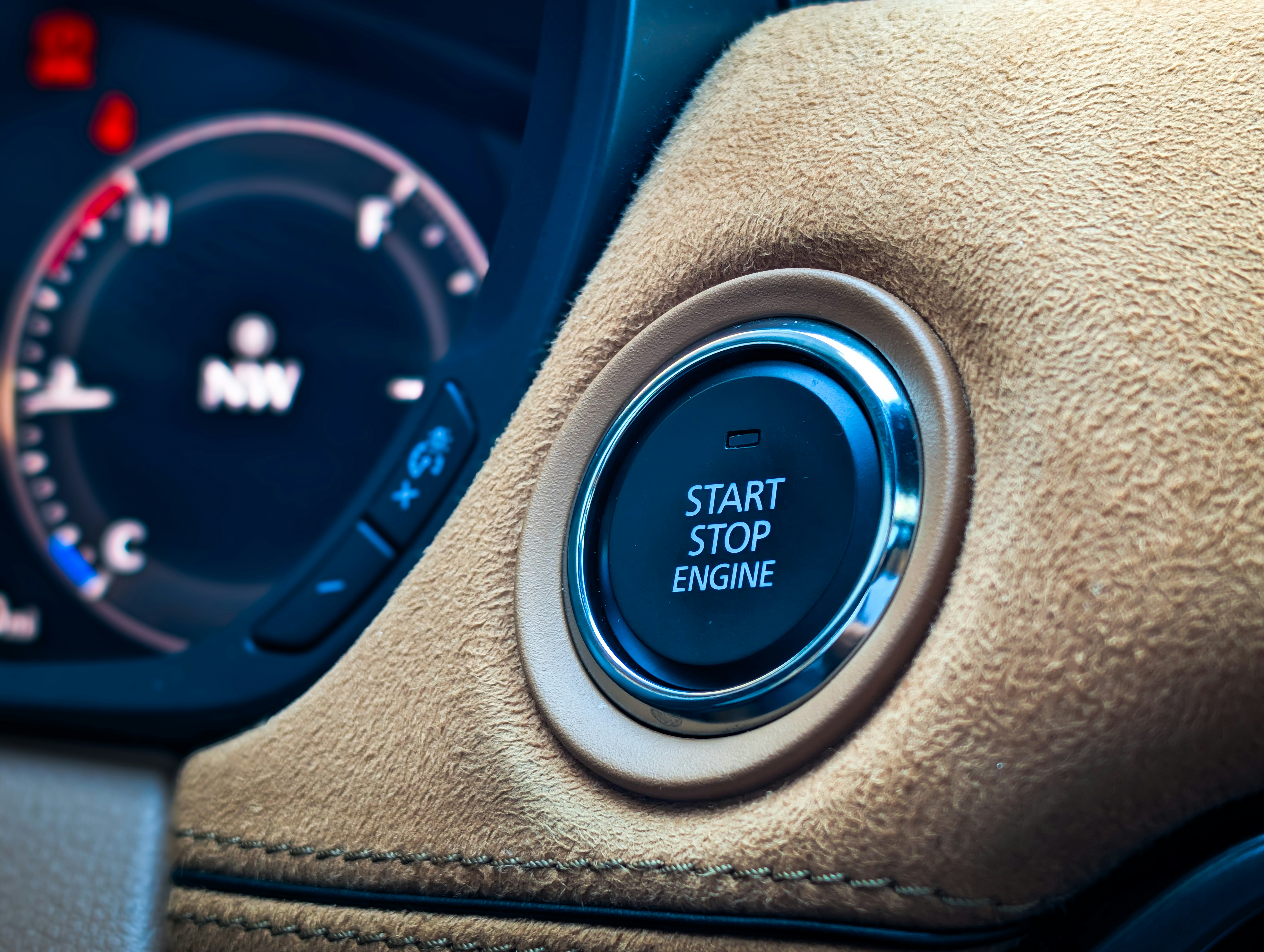 Start stop engine button in a car interior.