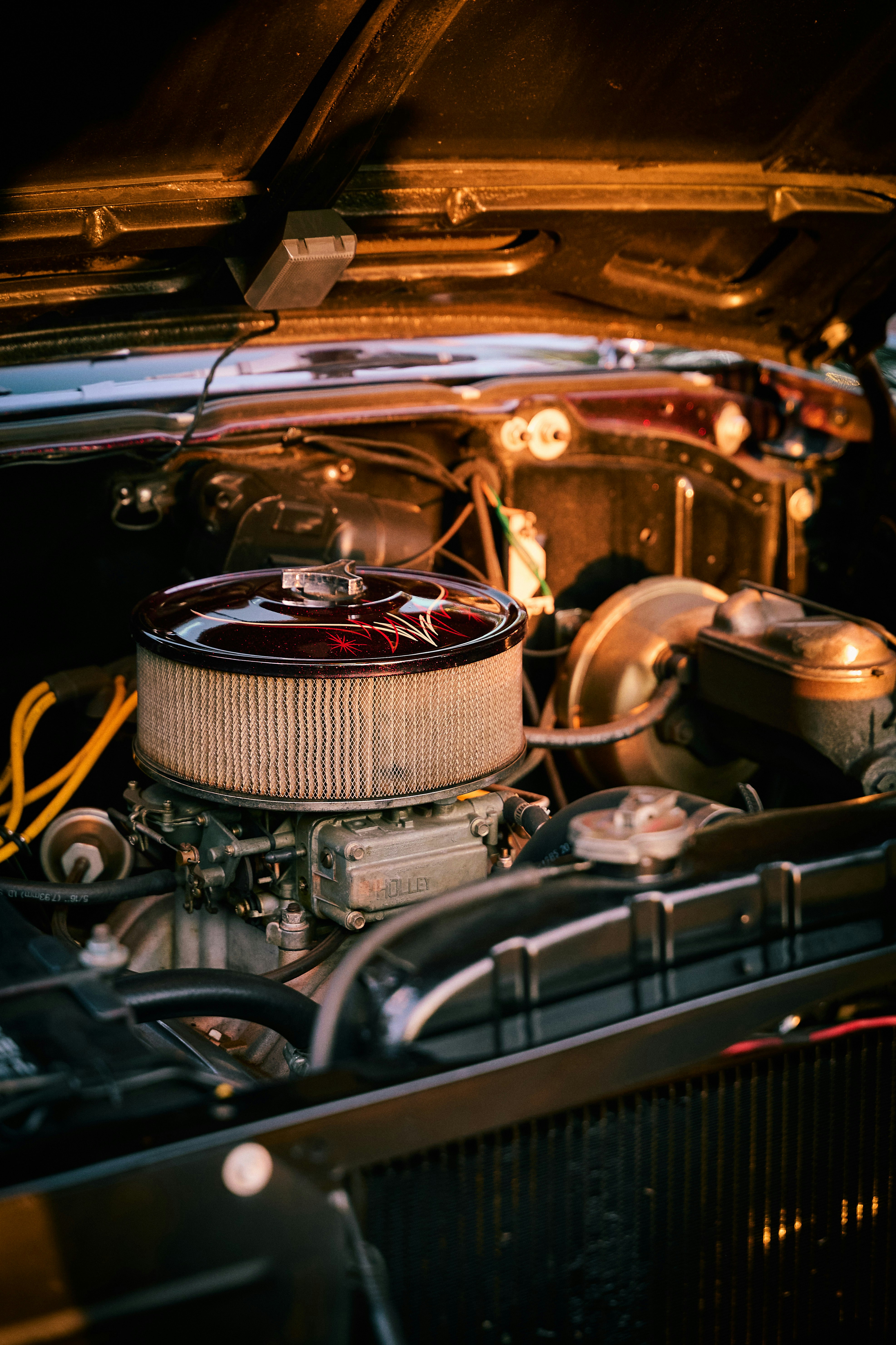 Close-up of a vintage car engine with chrome details.