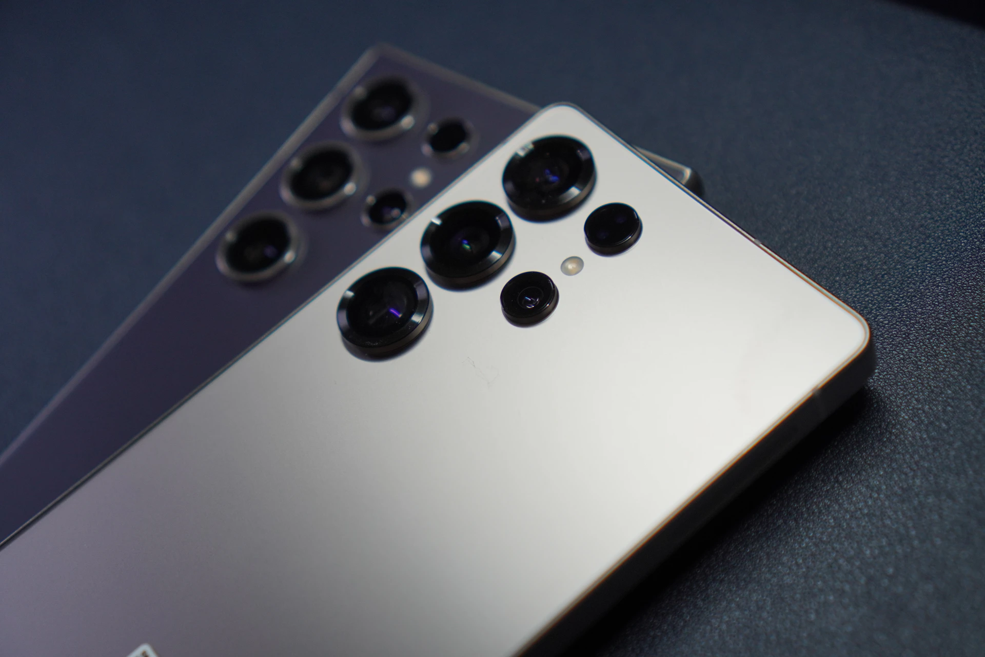 Two smartphones with multiple camera lenses.