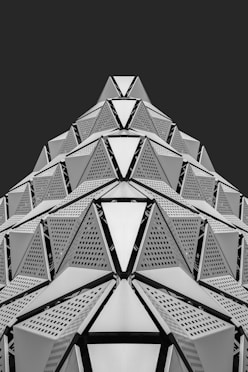 Geometric architectural structure with repeating triangular patterns.