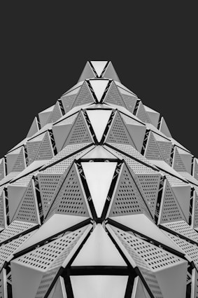 Geometric architectural structure with repeating triangular patterns.