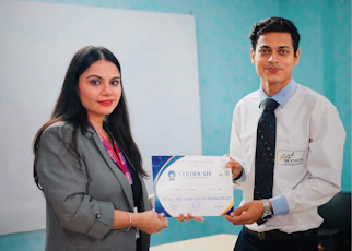Woman presents certificate to man in office