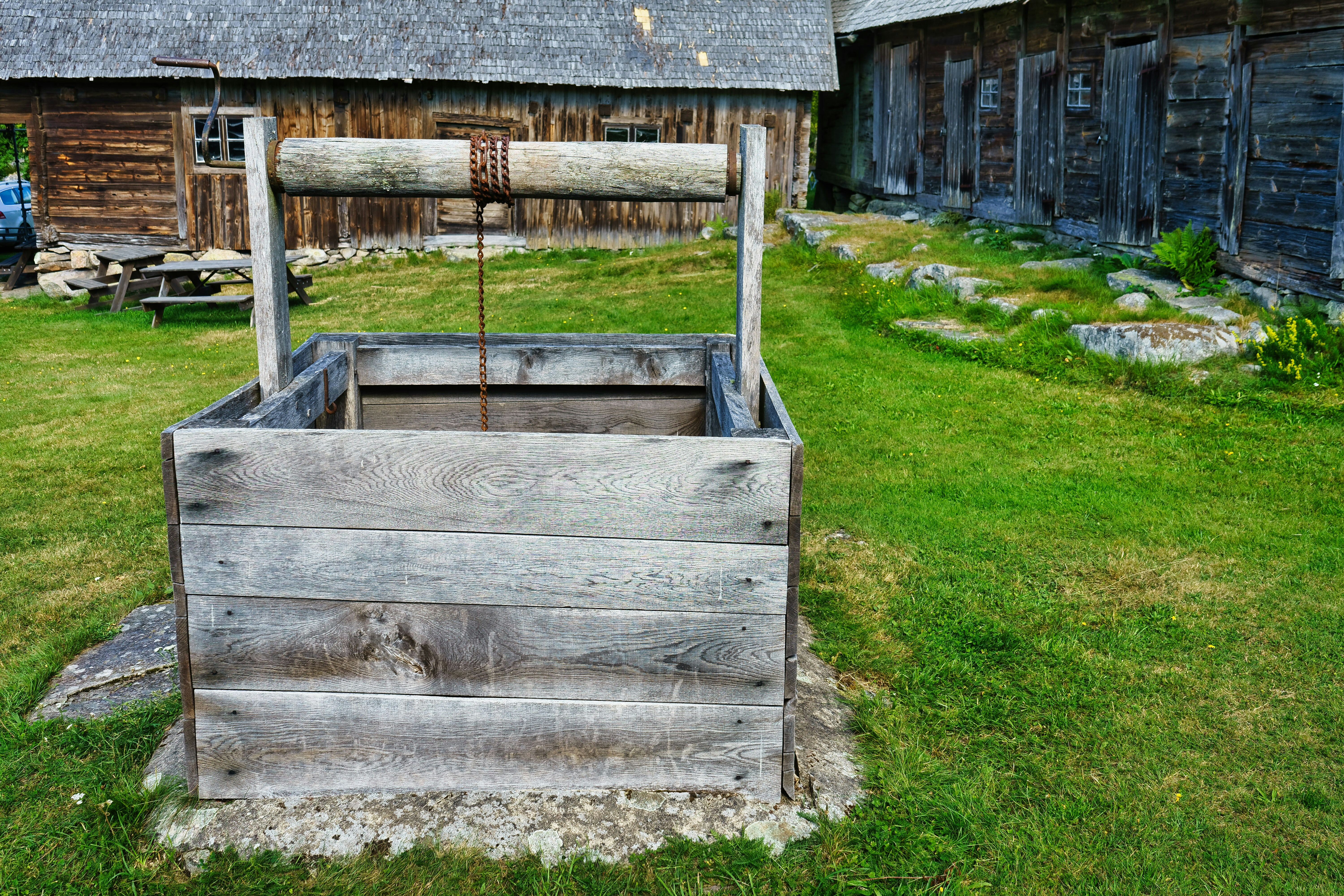 Old wooden well in a grassy yard